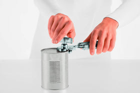 Rösle can opener in action shows effortless lid lifting without touching contents.