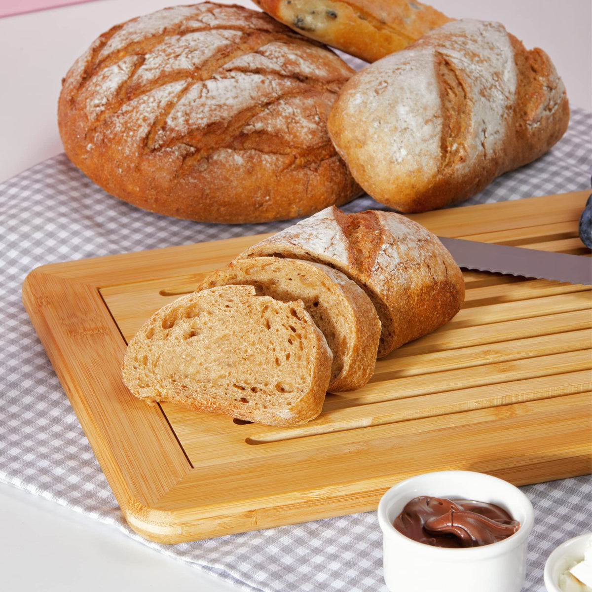 RoyalHouse crumb tray integrated into bamboo bread board for easy cleanup.