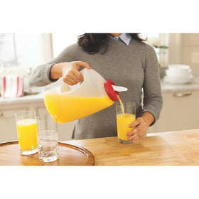 Rubbermaid 7E60 pitcher red handle view emphasizing easy grip and sturdy base.