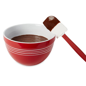 Rubbermaid silicone spatula with flexible blade for thorough bowl scraping.