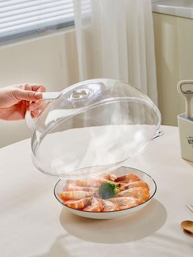 RUNZI clear splash guard resting on a plate, showcasing the see-through lid.