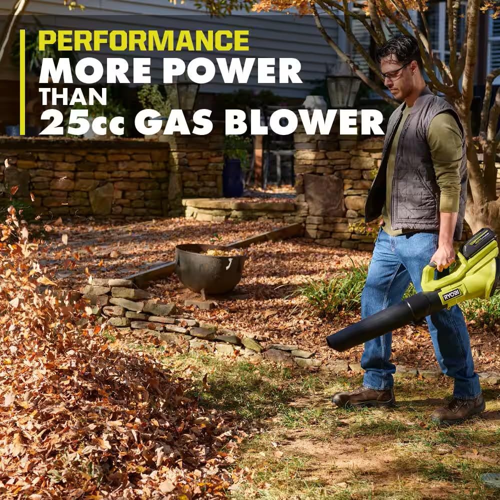 RYOBI 40V blower in use on driveway shows efficient leaf removal.