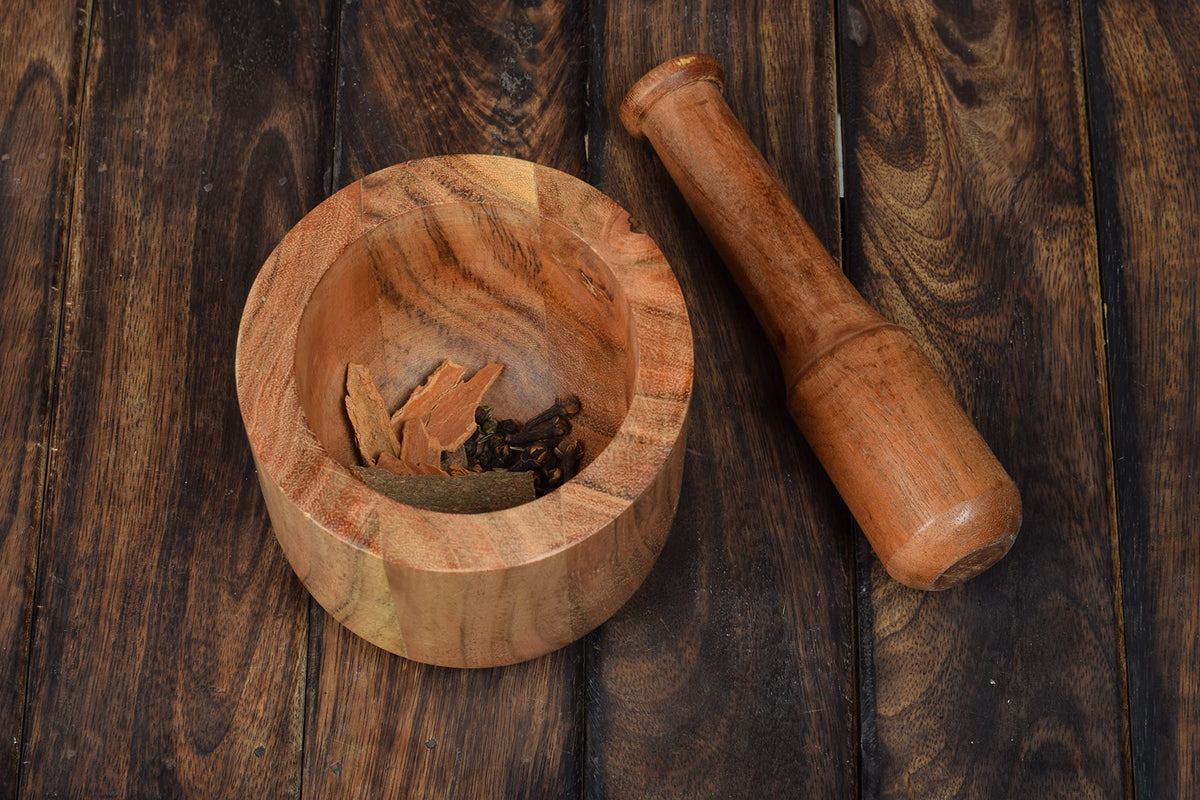 Samhita Acacia mortar and pestle care tips with damp cloth and oil.