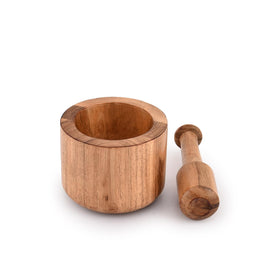 Samhita Acacia mortar and pestle grinding vanilla and pepper to release flavor.