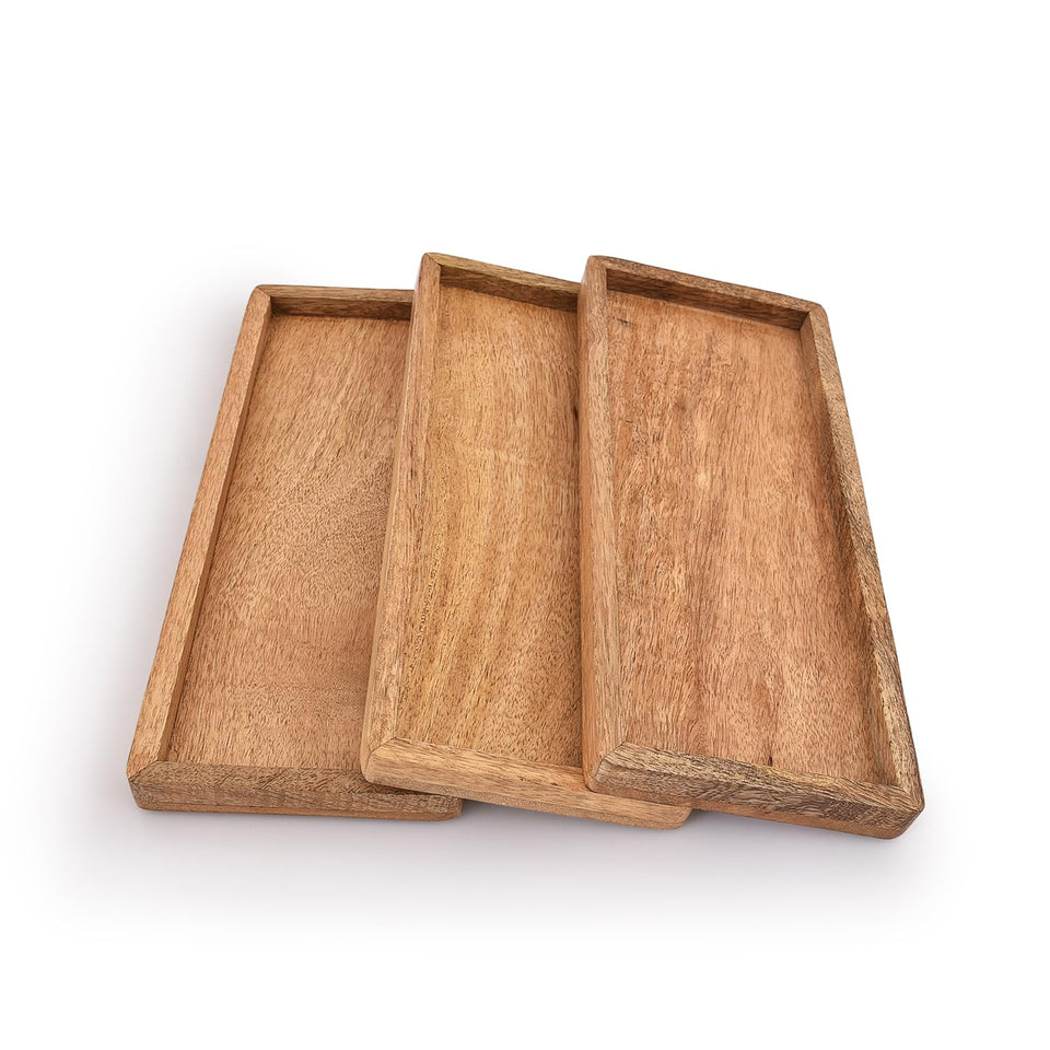 Samhita mango wood serving platter collection showcases warm grain for versatile party display.