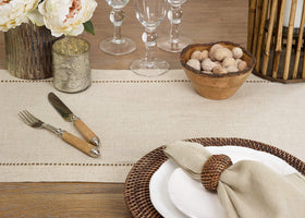 SARO LIFESTYLE hemstitch border runner draped on a dining table.