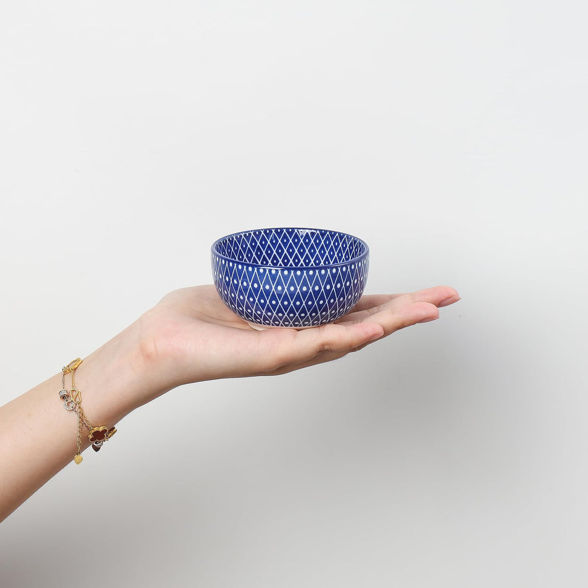 Selamica dipping bowls showcase blue pattern on inside and outside to enhance presentation.