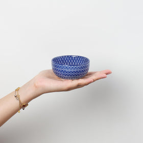 Selamica dipping bowls showcase blue pattern on inside and outside to enhance presentation.