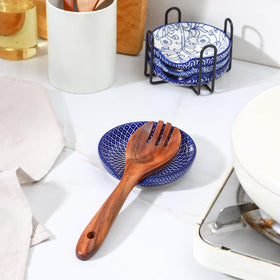 Selamica spoon rest shows circular depression design to keep spoons stable.