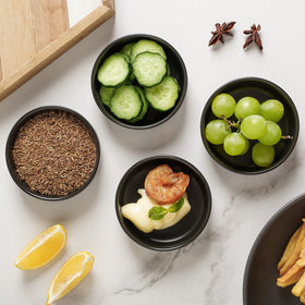 Selamica sushi dipping bowls on a plate for soy sauce and condiments.