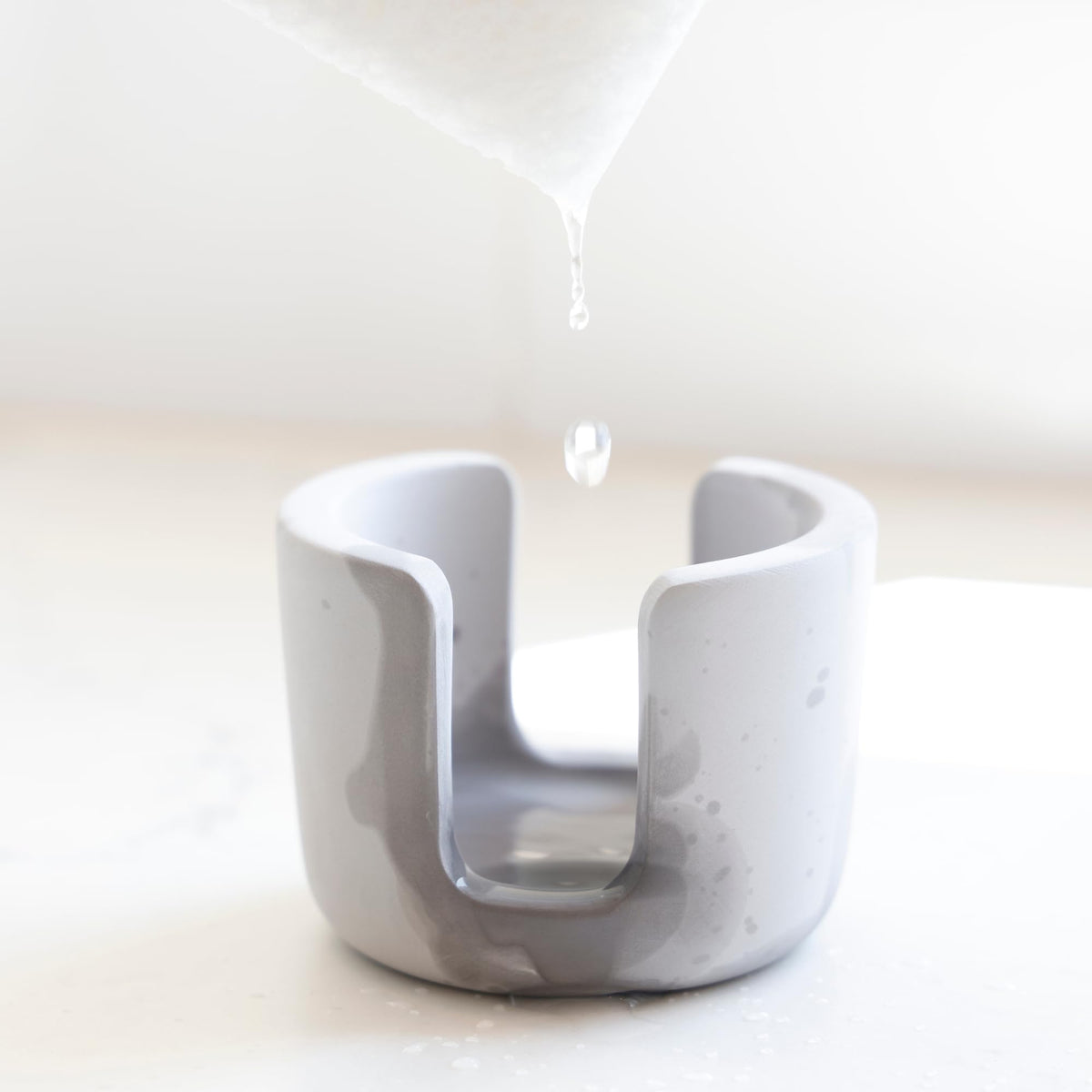 Selegna diatomite stone sponge caddy, side view, compact organizer saves space near the sink.