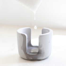 Selegna diatomite stone sponge caddy, side view, compact organizer saves space near the sink.