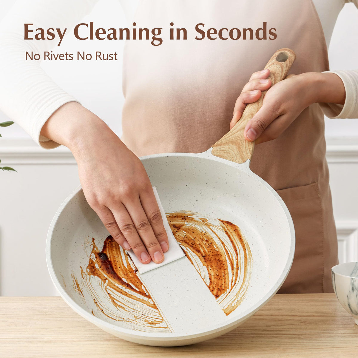 SENSARTE pan being wiped clean highlights easy maintenance.