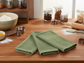 Serafina Home dark sage towels as decorative kitchen accents with practical utility.