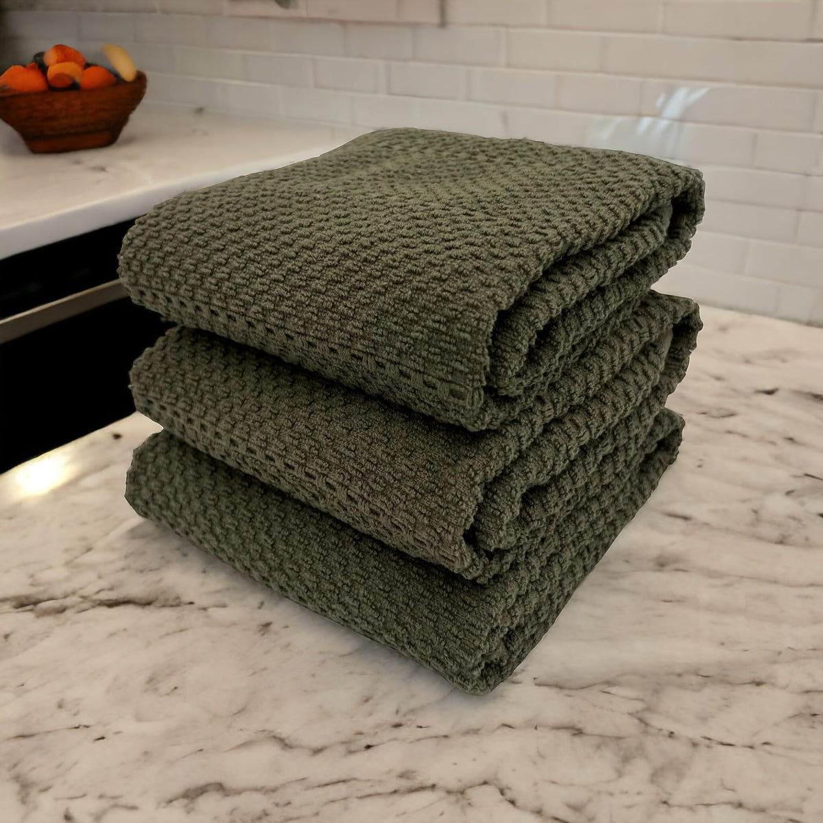Oversized Serafina Home olive green towels drying spills and cleaning surfaces efficiently.