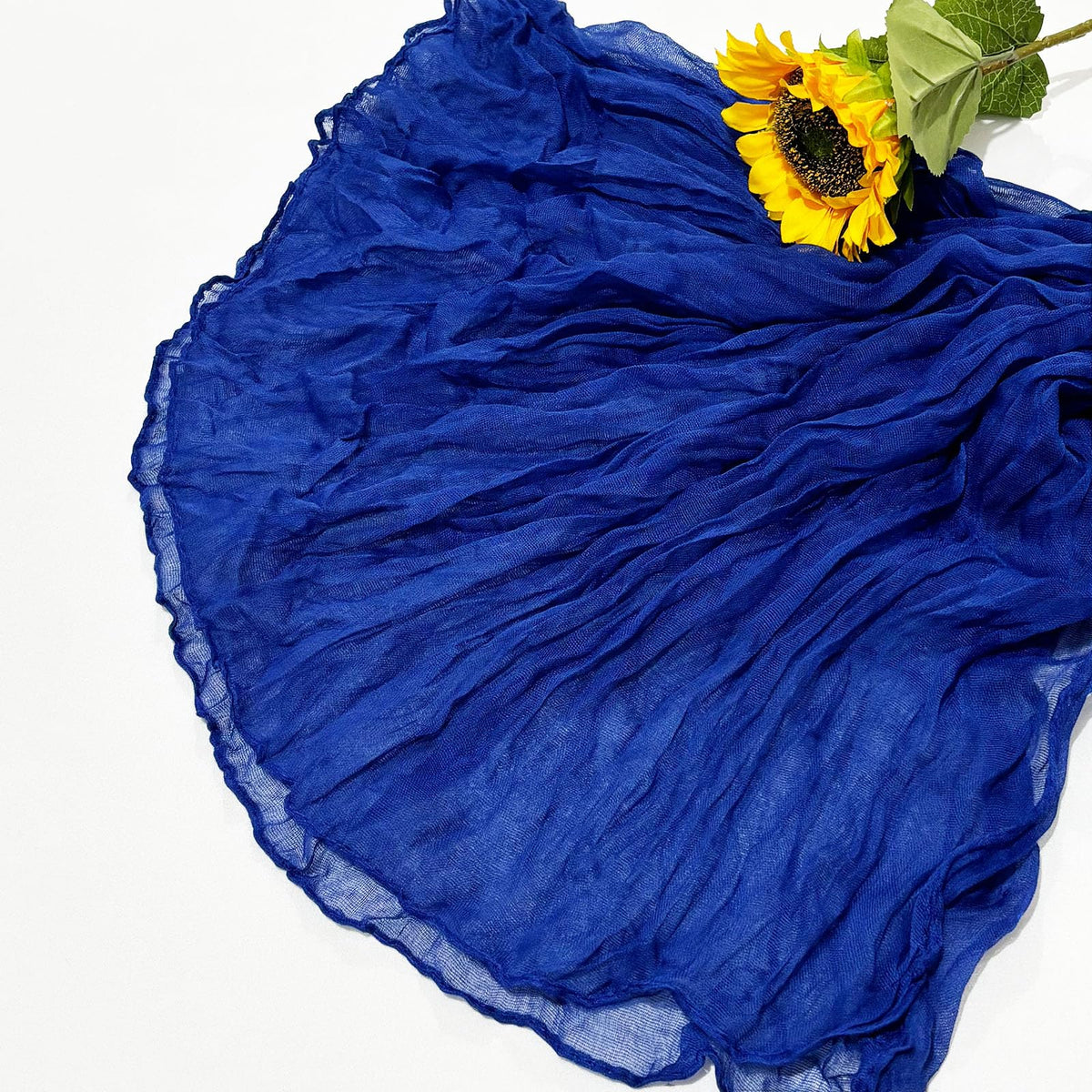 Seveups royal blue runner drapes as a backdrop to elevate wedding decor.
