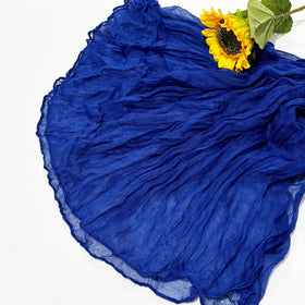 Seveups royal blue runner drapes as a backdrop to elevate wedding decor.