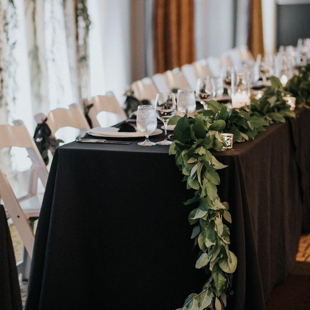 Seveups wedding banquet setup with black tablecloths creating a unified look