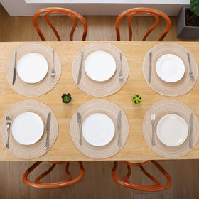 SHACOS beige round placemats complementing natural wood and greenery