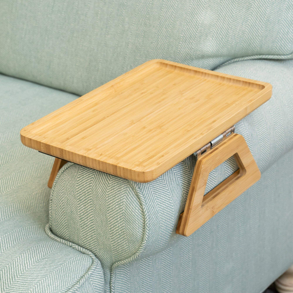 Shamrock Home Bamboo Trayble couch arm table closeup shows stable surface for meals.