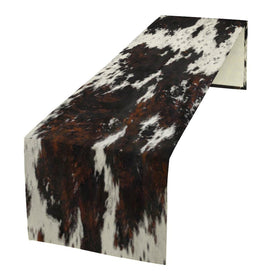 SHElifestyle cow skin print table runner adds rustic charm while protecting tabletops.