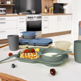 Shopwithgreen tableware in kitchen setting emphasizes dishwasher-safe cleanup.