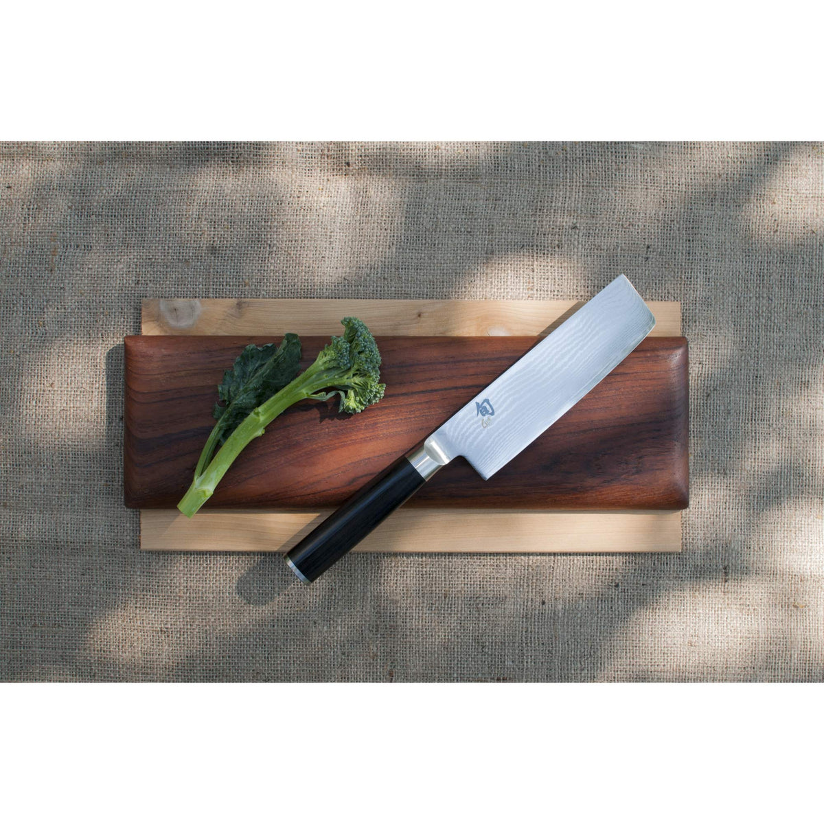 Shun Classic Nakiri knife handle with D-shaped PakkaWood grip.