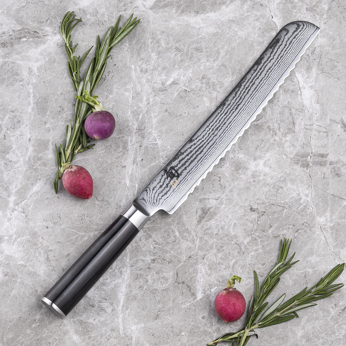 Shun Classic Damascus-clad blade reduces sticking for smooth pastry cuts.