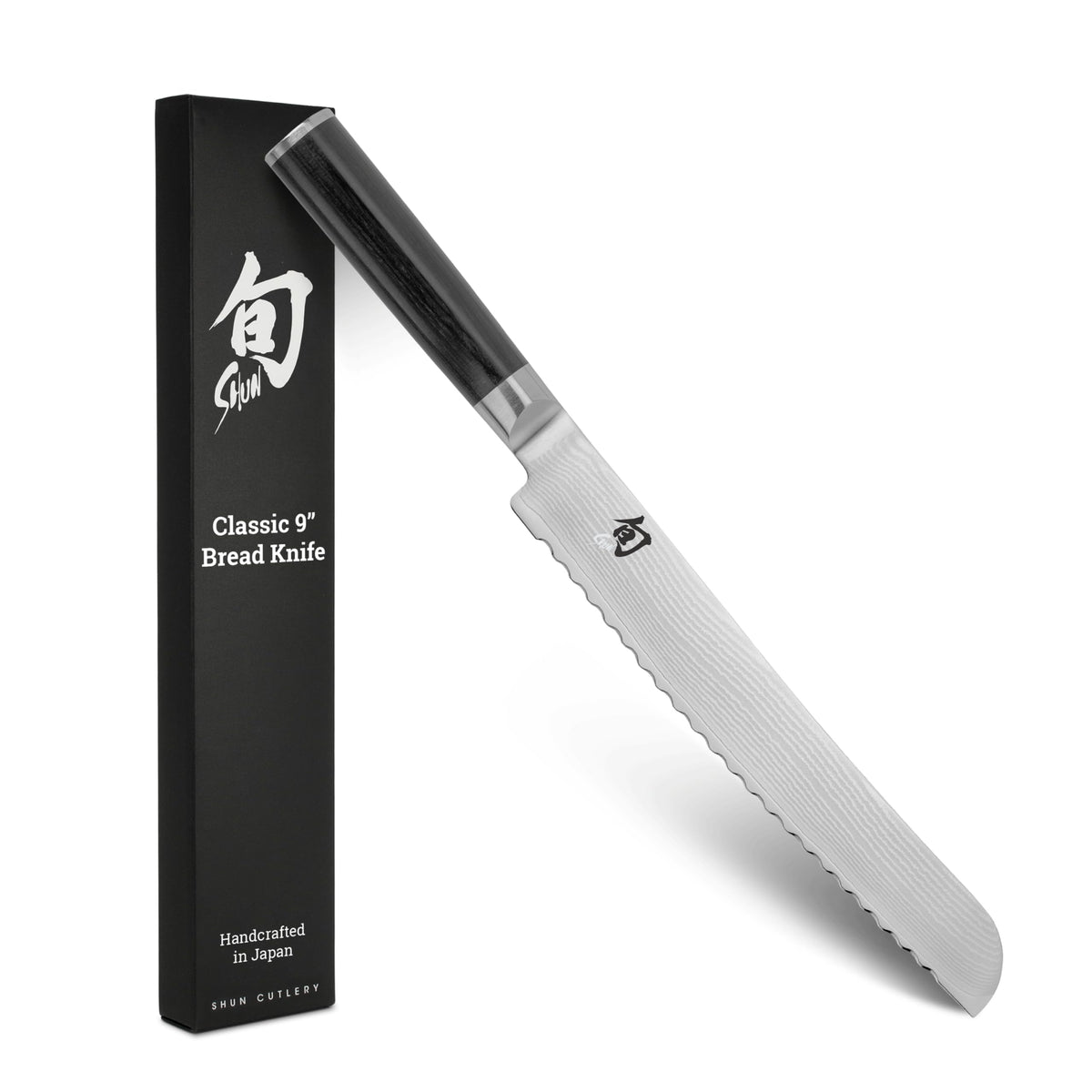 Shun Classic 9-Inch Bread Knife slicing crusty bread for even slices.