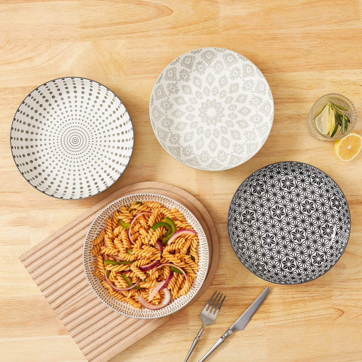 Signature Housewares pasta and salad bowls designed for serving and sharing.