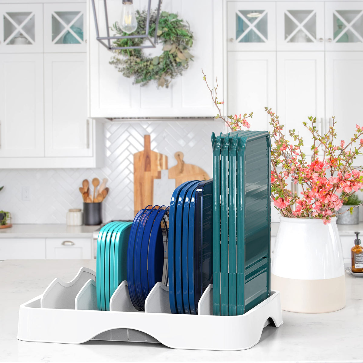 Simple Houseware adjustable dividers segment lids by size and shape for quick retrieval.