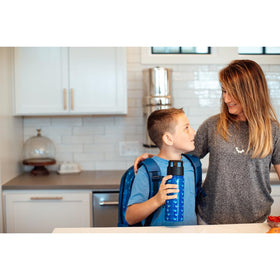 Simple Modern Summit bottle in a car cup holder, ideal for school commutes.