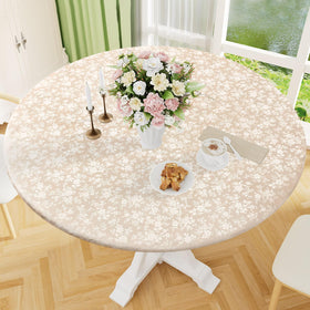 Smiry beige round tablecloth with embossed floral pattern and fitted edges for elegant dining.