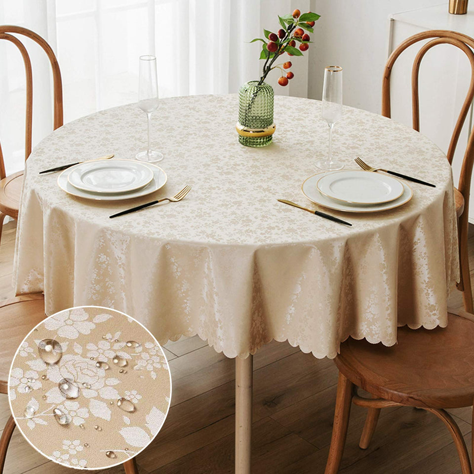 Smiry round beige table cloth, 70-inch round, with floral embossing and scalloped edge for elegant dining protection.