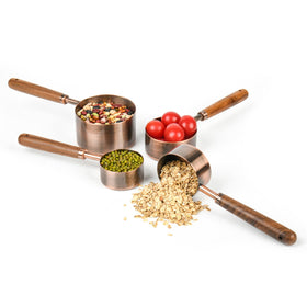 Smithcraft copper measuring cup 1/4-cup 60ml with wood handle for spill-free pouring.
