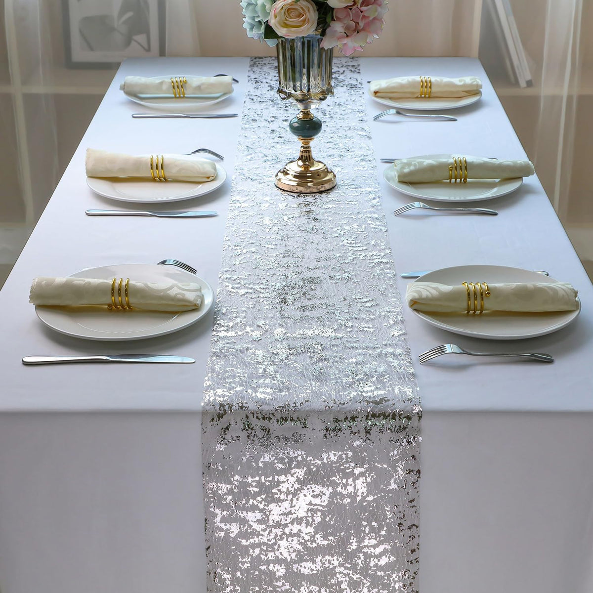 Snowkingdom wedding table decor with silver runner enhancing dining setup