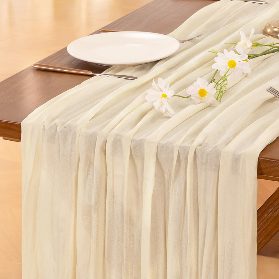Socomi beige cheesecloth table runner draped on a 120-inch table for festive dining.