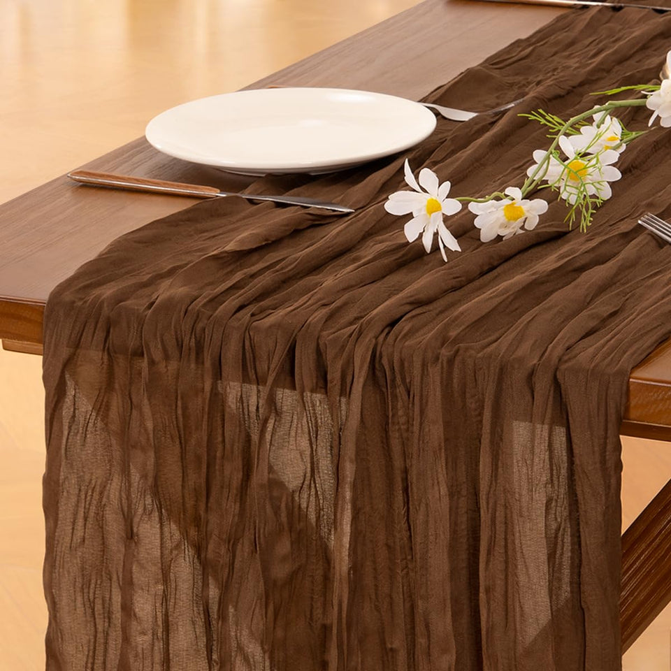 Socomi brown cheesecloth table runner on a long wedding table adds rustic charm
