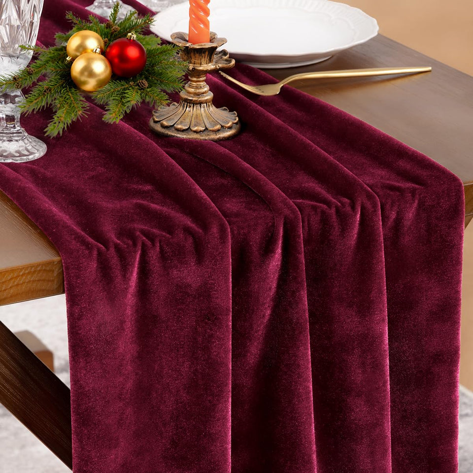 Socomi Burgundy Red Velvet table runner laid on a long dining table for an elegant look.