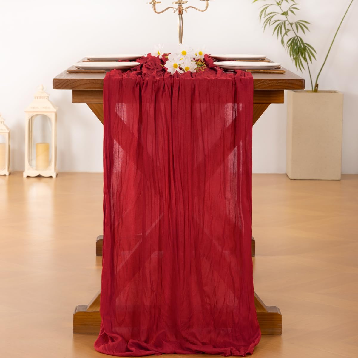 Socomi red cheesecloth runner on a festive dining table setup.