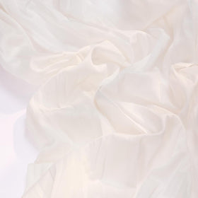 Socomi ivory cheesecloth runner on a wedding table for a soft gauze look.