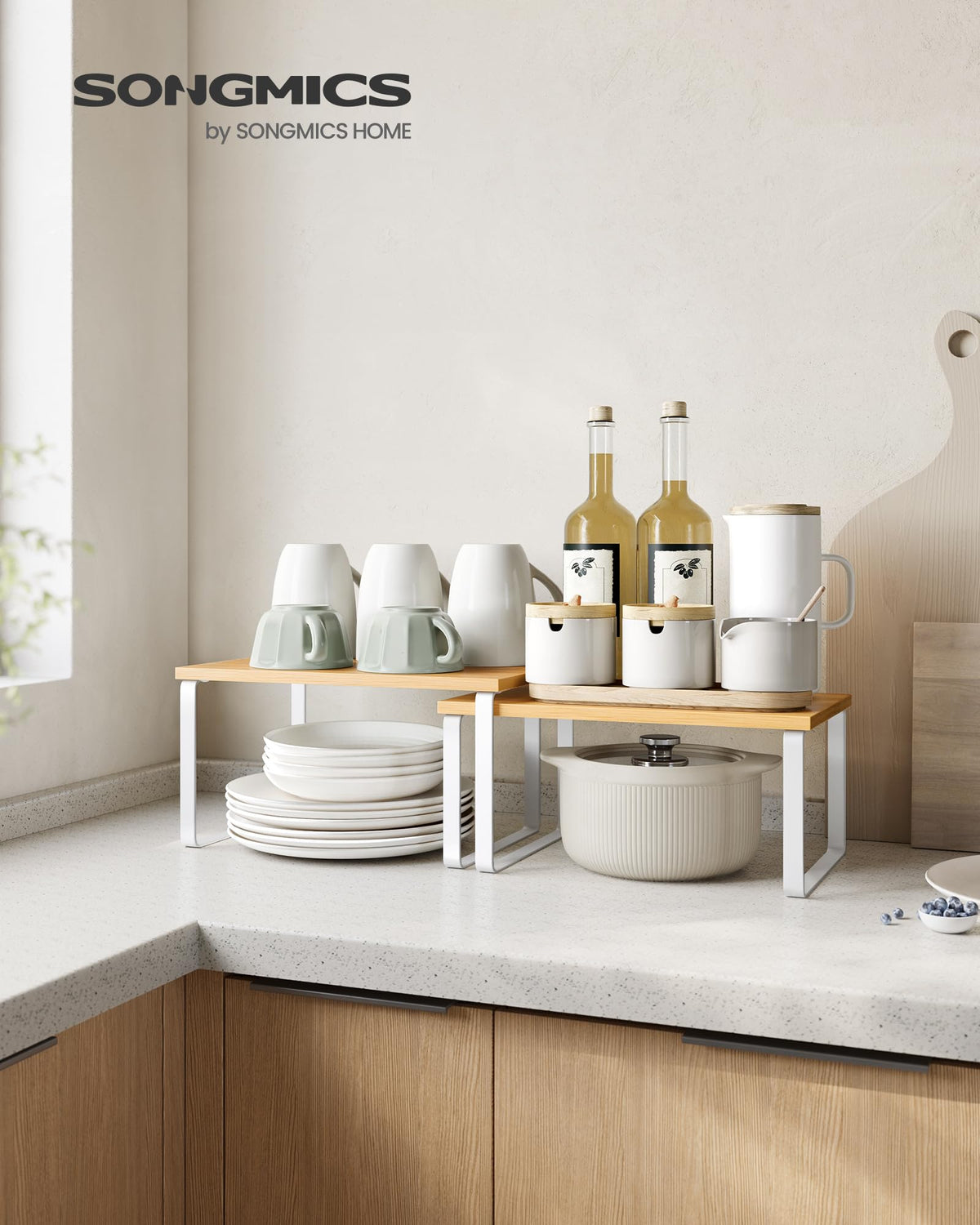 SONGMICS stackable kitchen shelves supporting jars, mugs, and small appliances.