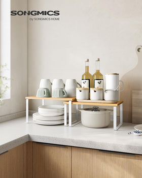 SONGMICS stackable kitchen shelves supporting jars, mugs, and small appliances.
