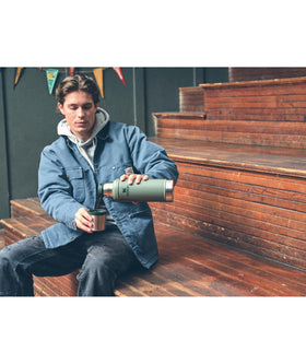 Stanley Classic bottle shown on camping setup proves reliable for tailgates, hikes, and trips.