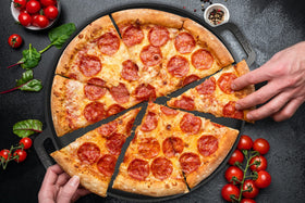 StarBlue pizza pan on stove ready for versatile baking and searing.