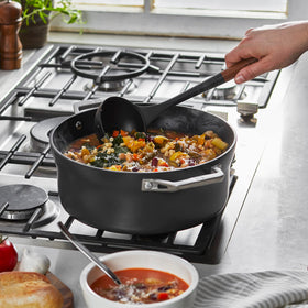 STAUB silicone ladle showing acacia wood handle for ergonomic grip