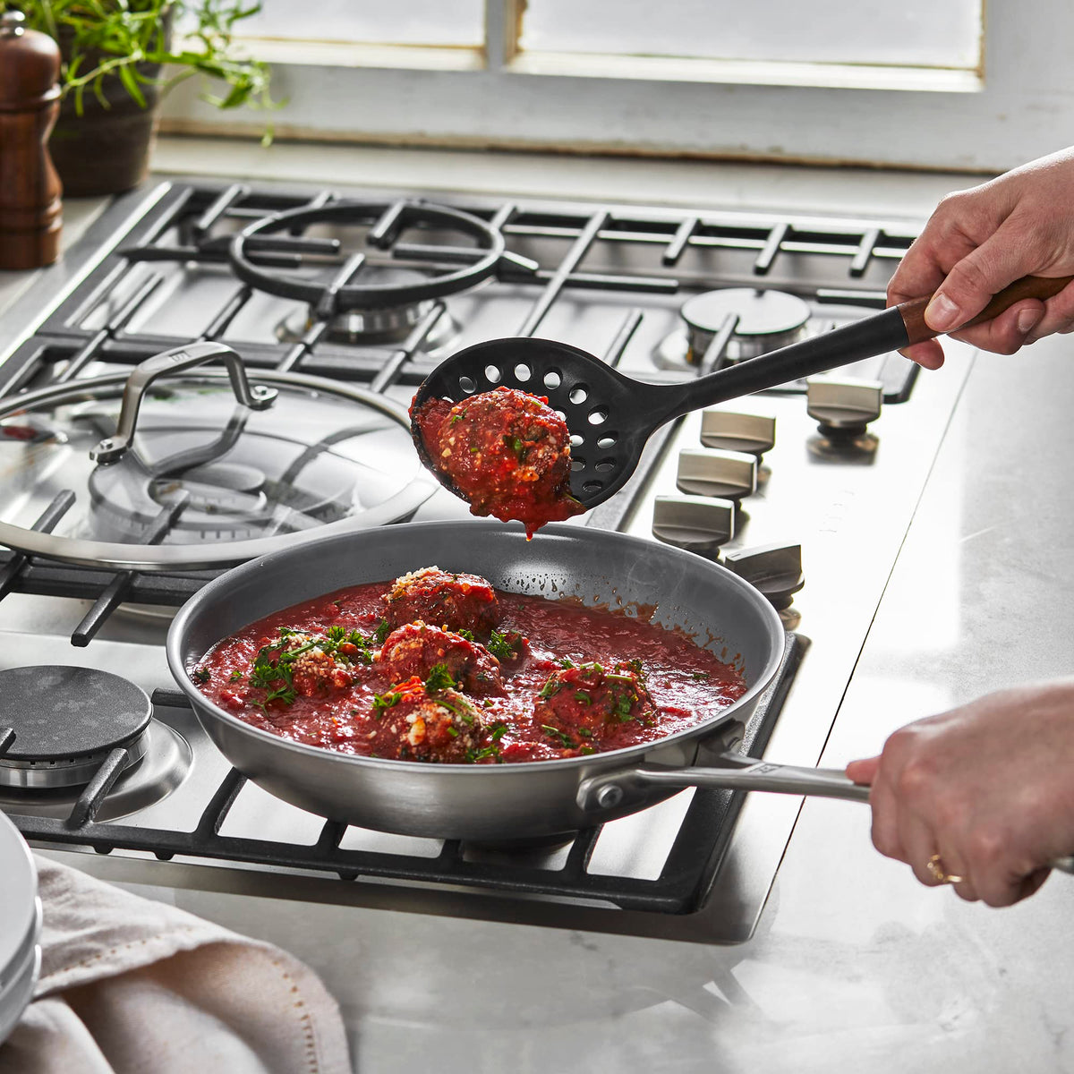 STAUB skimmer spoon with acacia wood handle and ergonomic grip