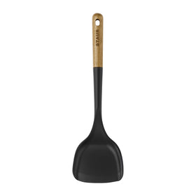 STAUB Wok Spatula designed to reach pan corners while turning stir-fries.