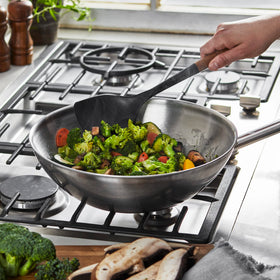 STAUB Wok Spatula ergonomic acacia wood handle enhances grip during stirring.
