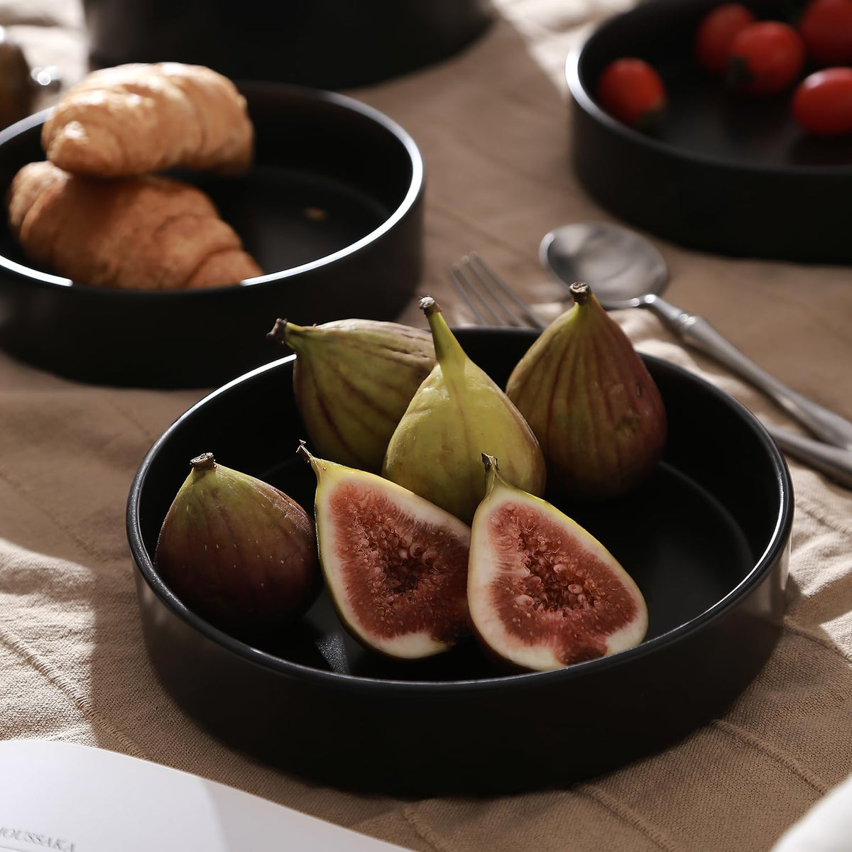 Bold black Celina stoneware elevates plating for salads and pasta.